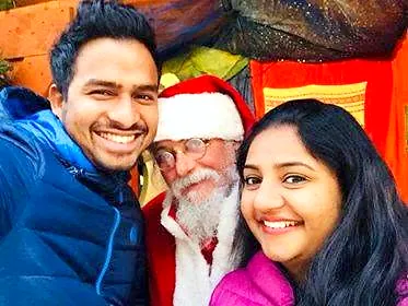 A couple taking a selfie with Santa